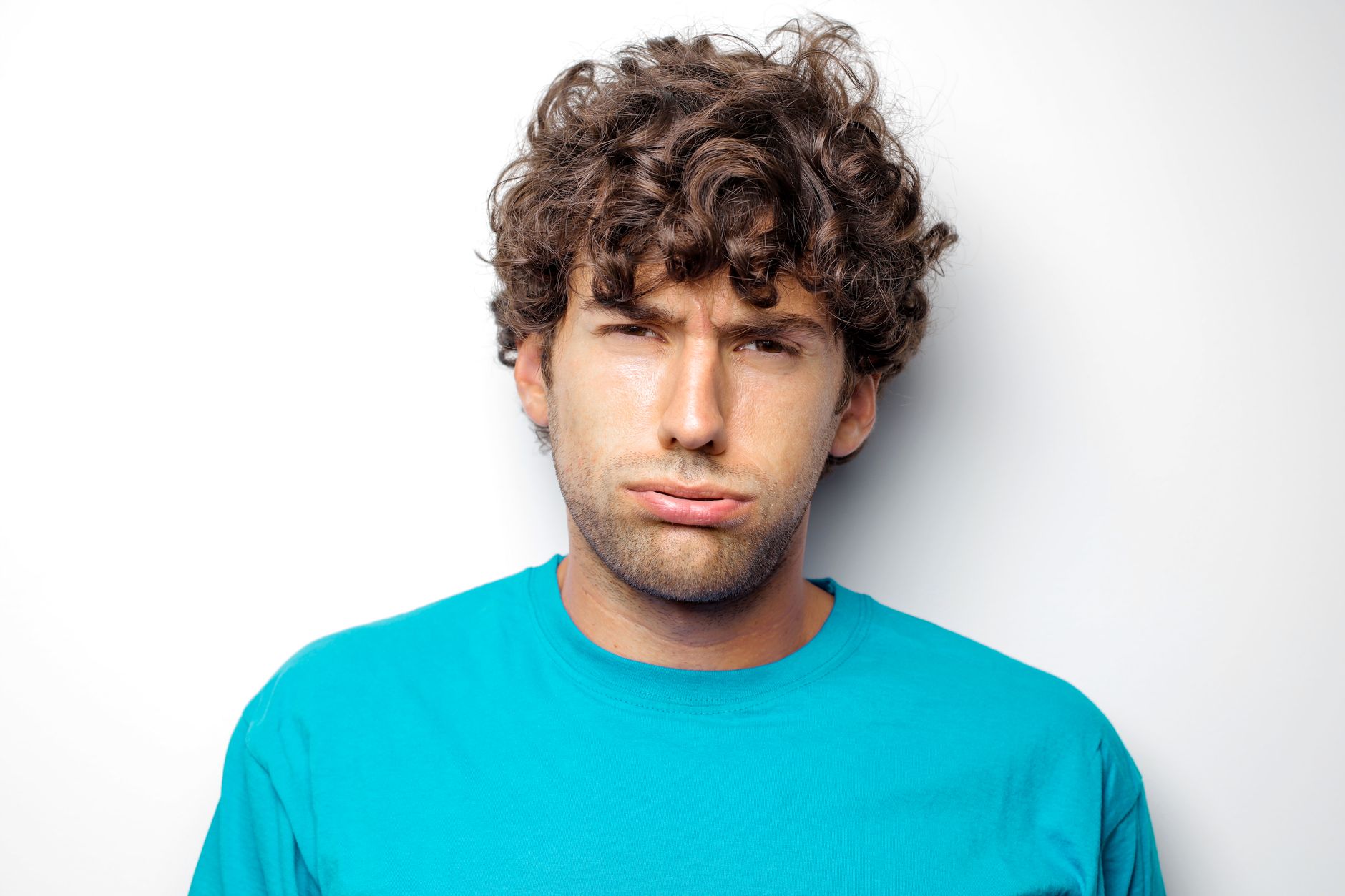 Homme aux boucles brunes sur le dessus, de face sur fond blanc