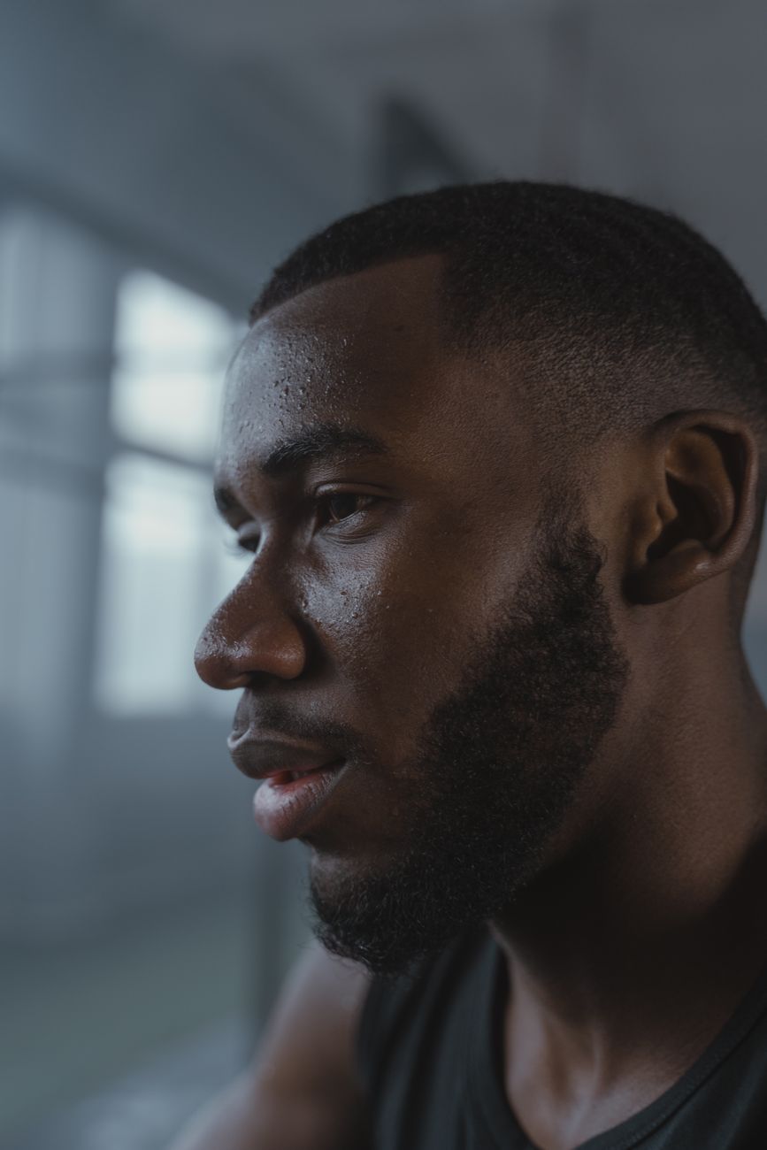 Homme de profil à la barbe courte le long de la mâchoire, lèvre supérieure rasée